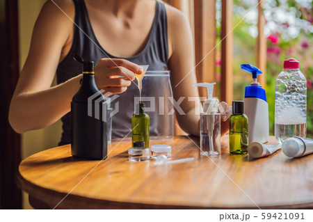 Travel kit for transporting cosmetics on an airplane. Cosmetics are ready to be poured into small Travel kit for transporting cosmetics on an airplane. Cosmetics are ready to be poured into small 59421091