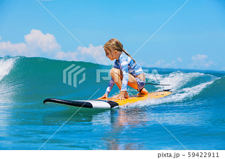 Young surfer rides on surfboard with fun on sea Young surfer rides on surfboard with fun on sea 59422911