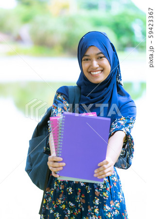 muslim girl student with books portrait 59423367
