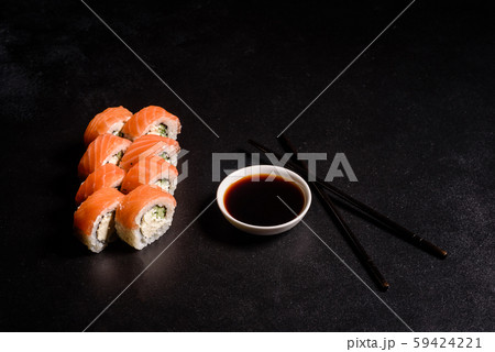 Various kinds of sushi served on a dark background 59424221