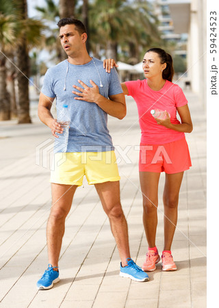 Tired couple resting after workout Tired couple resting after workout 59424523