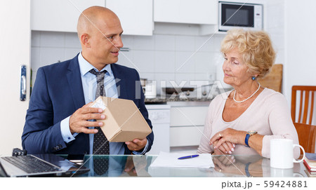 Agent showing box to woman Agent showing box to woman 59424881