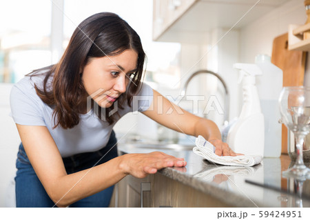 Young housewife washing furniture kitchen at home interior Young housewife washing furniture kitchen at home interior 59424951