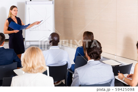 Young woman sharing business ideas with colleagues 59425098
