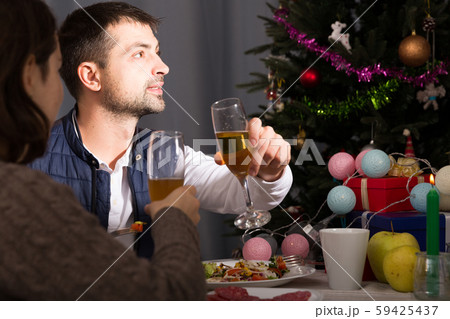 Couple having christmas dinner and watching tv Couple having christmas dinner and watching tv 59425437