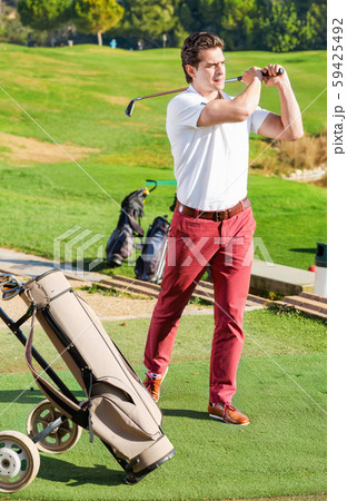 Male golf player made successful hit at golf course 59425492
