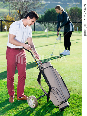 Male golfer is choosing right brassy 59425679