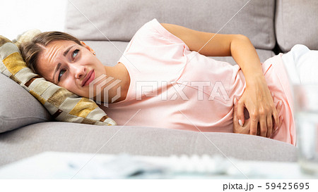 Woman suffering from abdominal pain 59425695