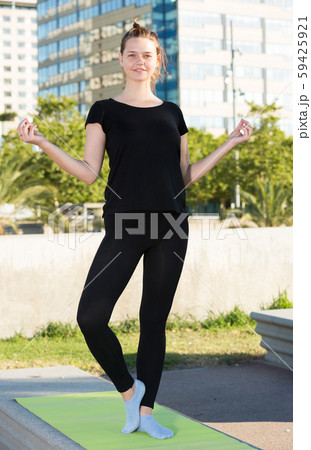 Young female during outdoor training yoga 59425921
