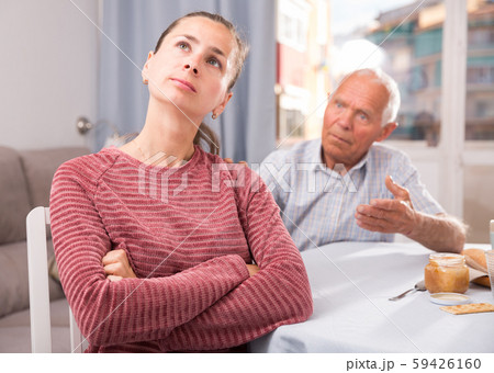 Portrait of upset young woman sitting after quarrel with father 59426160