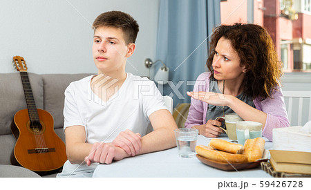 Worried mother talking to son Worried mother talking to son 59426728