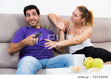 Couple arguing because of TV remote 59426906
