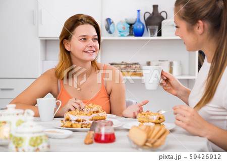 Two young female are drinking tea and talking about life 59426912