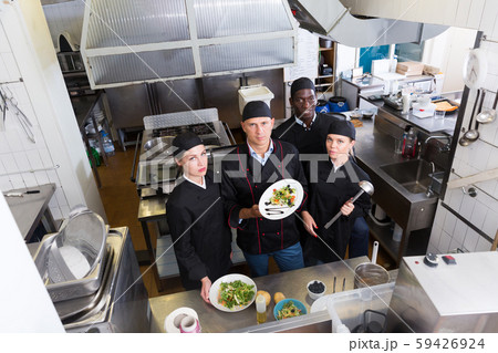 Group of chefs in kitchen of restaurant 59426924