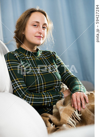 Woman relaxing on sofa 59427284