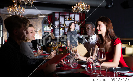 Men and women at luxury restaurant 59427528