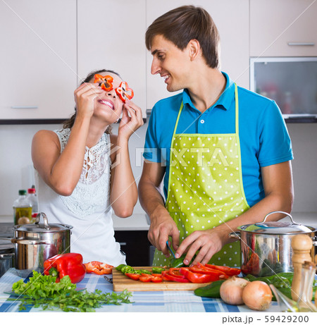 man and woman standing near table with vegetables man and woman standing near table with vegetables 59429200