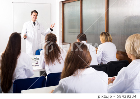 Multinational interns and professor having discussion 59429234