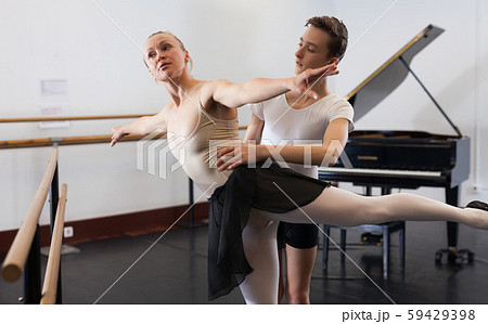 Ballet partners dancing gracefully together in the ballet studio 59429398