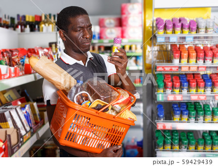 Man with cart shopping in store Man with cart shopping in store 59429439