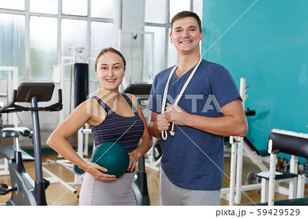 Man and woman posing standing at gym 59429529