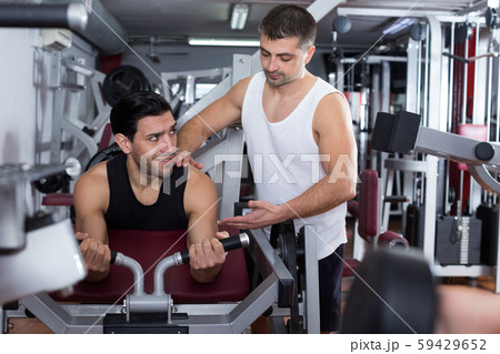 Man during training with instructor in gym Man during training with instructor in gym 59429652
