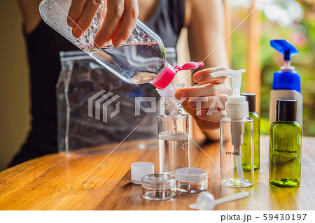 Travel kit for transporting cosmetics on an airplane. Cosmetics are ready to be poured into small Travel kit for transporting cosmetics on an airplane. Cosmetics are ready to be poured into small 59430197