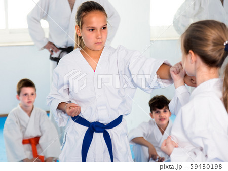 Young female children are trying in sparring to use new moves Young female children are trying in sparring to use new moves 59430198