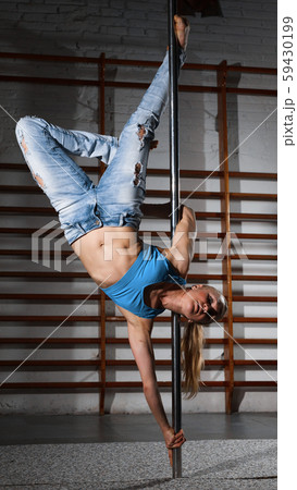 Girl engaged on pylon in semidarkness Girl engaged on pylon in semidarkness 59430199