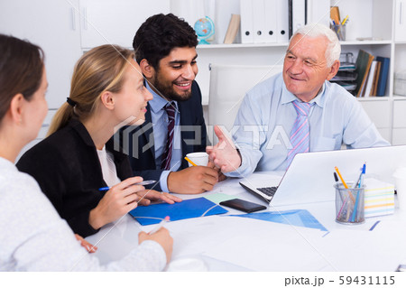 Employees are working together at computer Employees are working together at computer 59431115