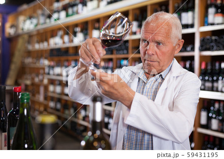 Sommelier tasting wines in winery 59431195