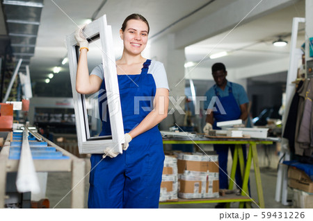 Female master is working with window frame Female master is working with window frame 59431226