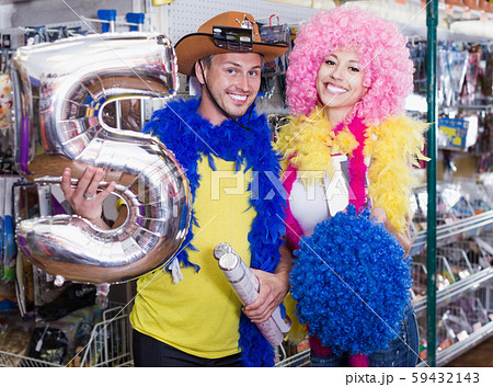 Young man with girlfriend trying on cowboy hat Young man with girlfriend trying on cowboy hat 59432143