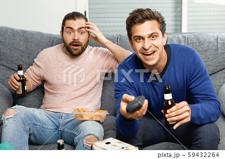 Men rejoice in the victory of their favorite team on TV Men rejoice in the victory of their favorite team on TV 59432264