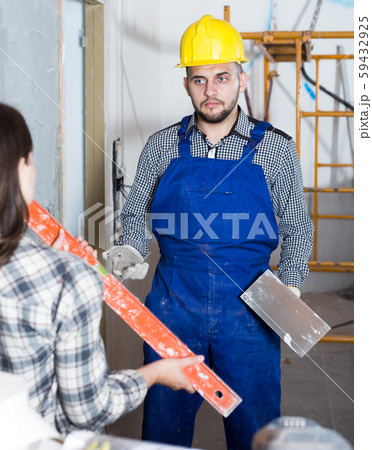 Female customer is checking what worker done Female customer is checking what worker done 59432925