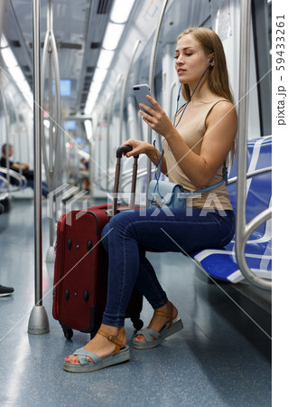 Woman with headphones in subway Woman with headphones in subway 59433261