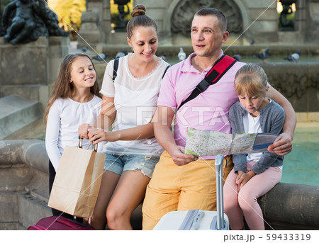 parents with two kids traveling together searching location on paper map parents with two kids traveling together searching location on paper map 59433319