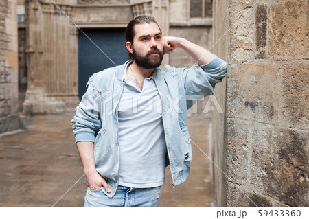 Handsome adult man with a beard in a jeans jacket Handsome adult man with a beard in a jeans jacket 59433360