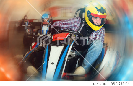 Portrait of lucky man driving racing car Portrait of lucky man driving racing car 59433572