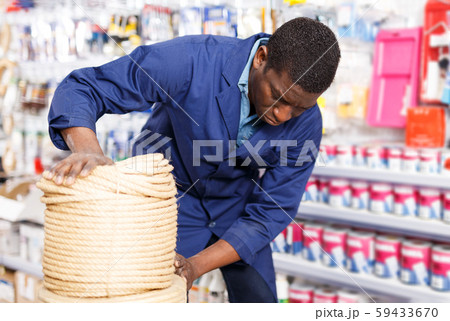 seller organizing assortment of items on shelves and racks seller organizing assortment of items on shelves and racks 59433670