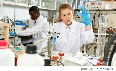 Woman scientist working in research laboratory with collegues Woman scientist working in research laboratory with collegues 59433674