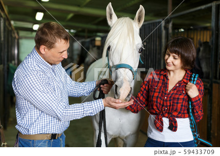 Portrait of man and woman with roan horse 59433709