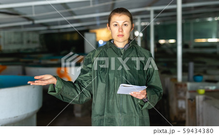 Woman at trout breeding incubator Woman at trout breeding incubator 59434380