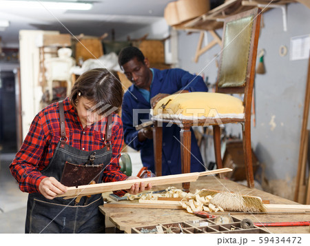 Restorers working with wooden furniture Restorers working with wooden furniture 59434472