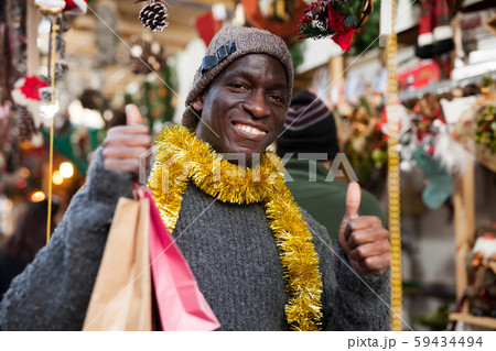 Laughing guy after shopping on Christmas market Laughing guy after shopping on Christmas market 59434494
