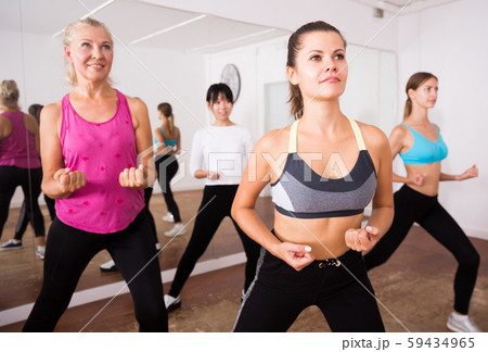 Fitness women practicing zumba movements Fitness women practicing zumba movements 59434965