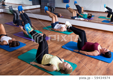Adults having yoga class in sport club 59434974