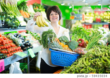 Mature woman buying fresh fruits and vegetables 59435034