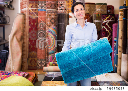 Female keep in hand colored carpet in interior shop Female keep in hand colored carpet in interior shop 59435053