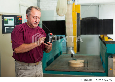 Elderly master manages 3d machine in factory Elderly master manages 3d machine in factory 59435375